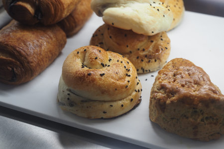 Baked goods on display in a bakery setting with sweet aromas