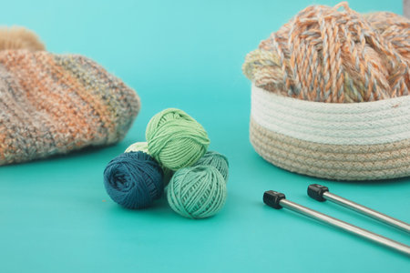 Knitting setup with yarn and tools on a blue background