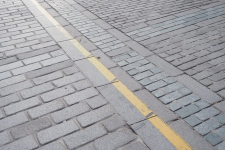 Paved street with yellow line on the road surface