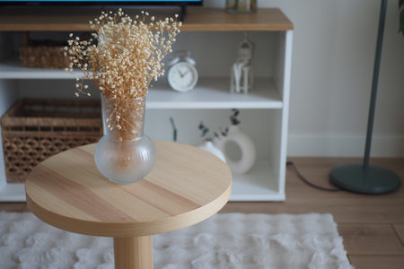 Wooden table with flower vase in modern living room setup