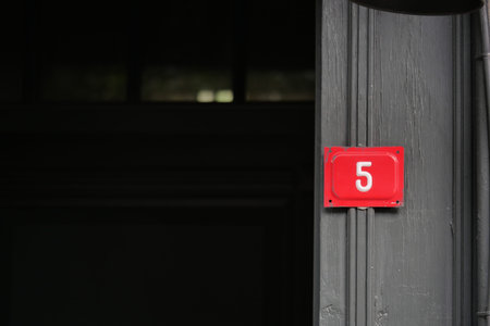 Number 5 set on a door in a dark building