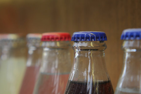 Bottles with colorful caps arranged on a shelf