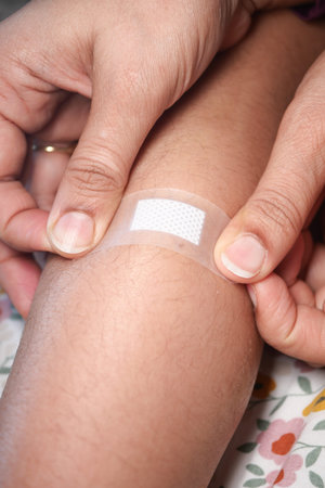 Applying a bandage on a knee after a minor injury