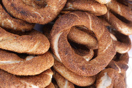 turkish simits are stacked in a market display