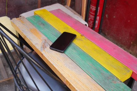 Smartphone on colorful table in outdoor setting. lost smart phone concept