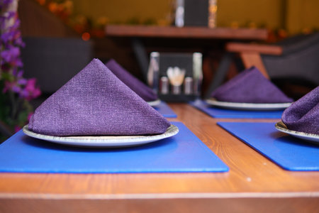 Table setting with napkins and plates in a dining area