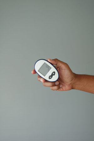 Hand holds a diabetic measurement tools checking health status
