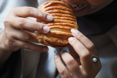 Enjoying fresh pastry at a cozy cafe in the morning