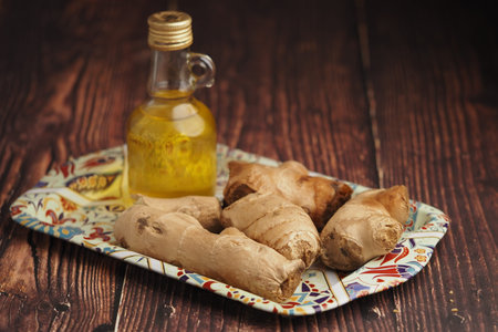Ginger root and oil on a colorful dish in a kitchen
