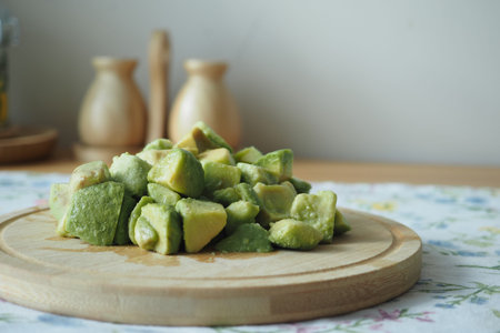 Freshly cut avocados on a wooden board in the kitchen