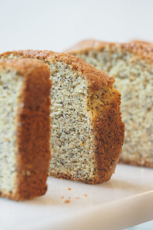 Banana bread sits on a white plate in a kitchen setting