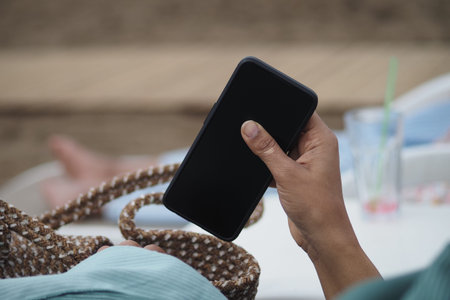 Person putting a smart phone in a bag