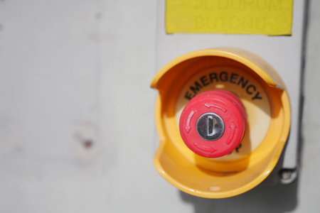 Red emergency button in a control panel at a facility