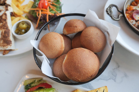 Fresh rolls served in a basket at a restaurant table