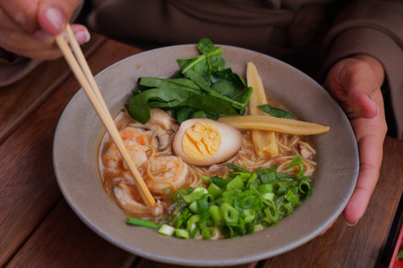 Delicious bowl of ramen with fresh toppings and shrimp