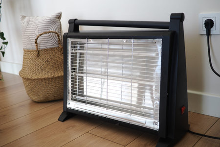 Portable heater placed near basket in indoor space