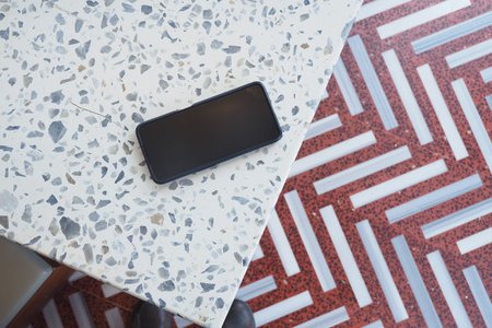 Smartphone placed on a table in a cafe setting. lost smart phone concept