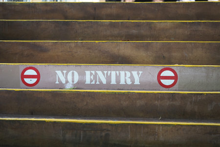 Stairs marked with warnings in a busy urban setting
