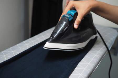 Ironing clothes on an ironing board in a room