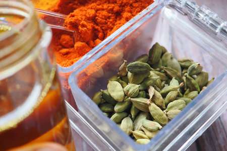 Various spices and honey seen on a kitchen counter