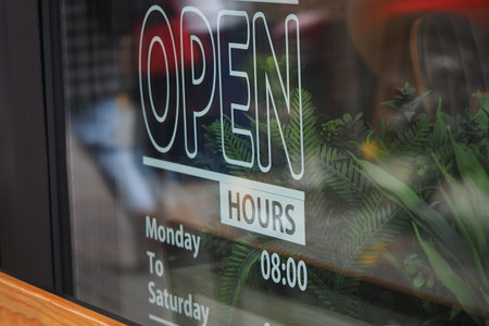 Business hours sign displays open status for visitors