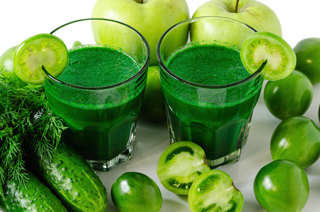 green smoothies with fresh vegetables and fruits, healthy nutrition concept, isolated on white backgroundの写真素材