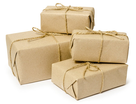 gift wrapping from Kraft paper wrapped with twine, the concept of handmade, isolated on white...