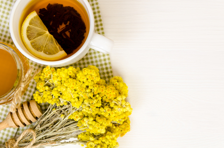 tea cup with dry flowers, on wooden backgroundの写真素材
