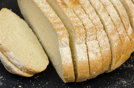 Healthy sliced homemade bread on wooden background.