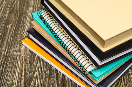 folded stack of workbooks. On wooden backgroundの写真素材