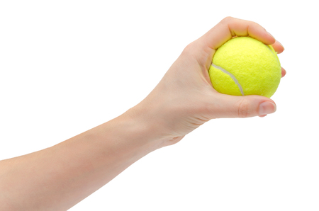 hand of young girl holding tennis ball. Isolated on white backgroundの写真素材