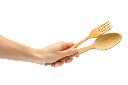 hand of young girl holding spoon and fork. Isolated on white backgroundの写真素材