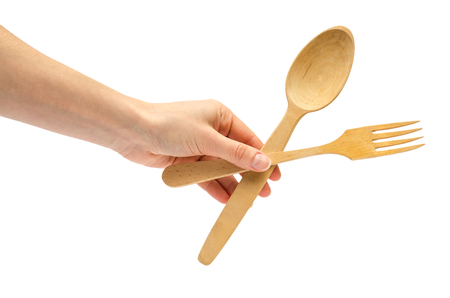 hand of young girl holding spoon and fork. Isolated on white backgroundの写真素材