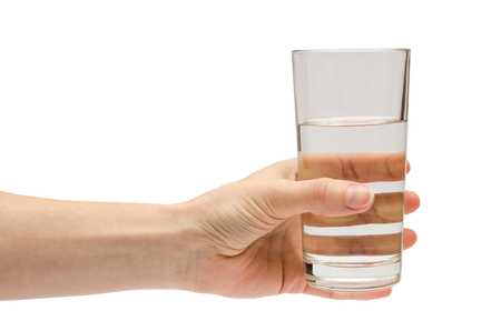 hand of young girl holding water glass. Isolated on white backgroundの写真素材