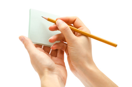 hand of girl holding pencil. Isolated on white backgroundの写真素材