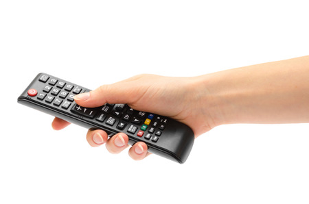 woman hand holding remote control. Isolated on white backgroundの写真素材