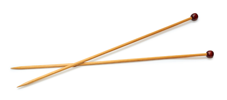 wooden knitting needles, lie crossed. Isolated on white backgroundの写真素材