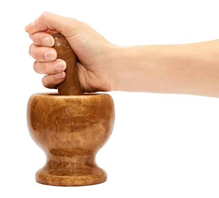 female hand uses a stone mortar to prepare spices. Isolated on white backgroundの写真素材