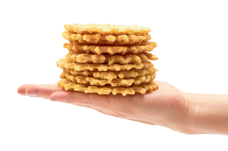 female hand holds homemade crisp Waffle. isolated on white backgroundの写真素材