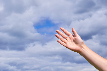 Girl reaches out his hands to the sky, thanks or asking for help. The concept of religion and...