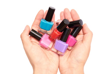 closeup of nail polish in the hand. Isolated on white background.の写真素材