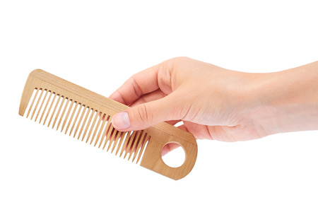 Hand holding hair brush isolated on white background.の写真素材