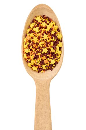 Wooden spoon with sprinkles for backing. Isolated on white background.の写真素材