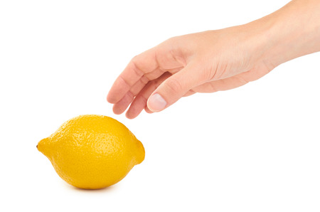 female hand holding lemon. Isolated on white background.の写真素材