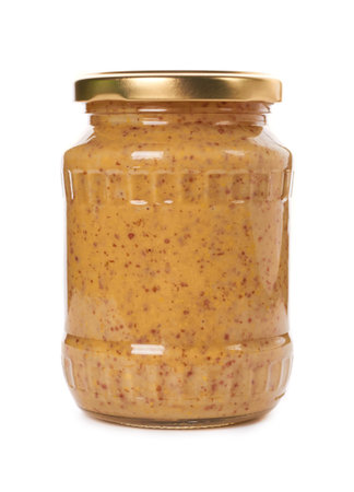 home made mustard in glass bottle isolated on white background.の写真素材