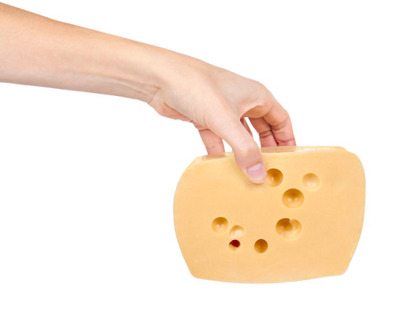 block of cheese in hand isolated on white background.の写真素材