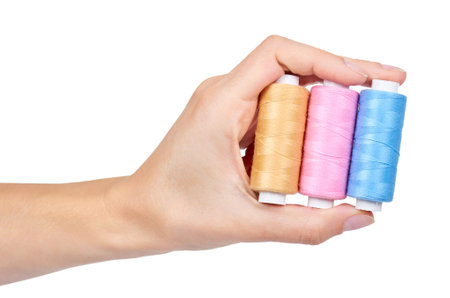 spool of thread in hand isolated on white background.