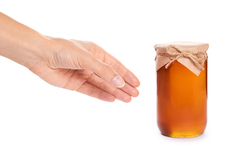 eco home made honey in jar in hand isolated on white background.の写真素材