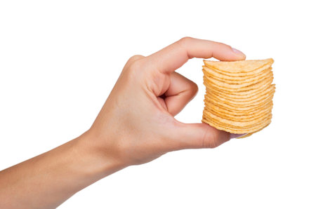 Potato chips in hand isolated on white background.の写真素材