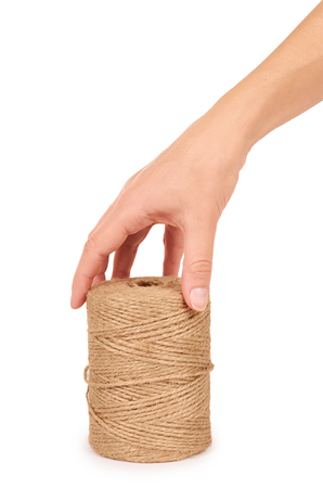Spool of bale twine isolated in hand on white background.の写真素材